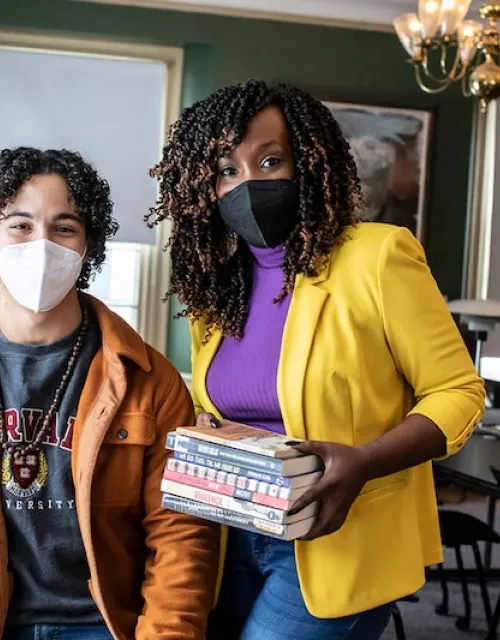DeAnza Cook (right) with student member Luke Walker at Cabot House Library, where the Cabot Prison Abolition Book Club meets.