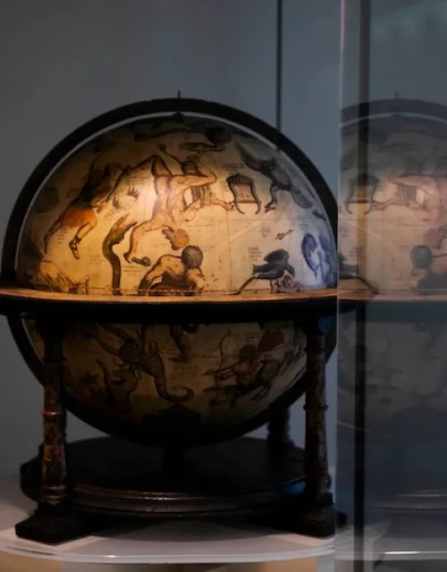 Mercator celestial globe from mid-1500s resides in the Pusey Library hallway gallery, outside the Map Collection, along with its terrestrial companion.