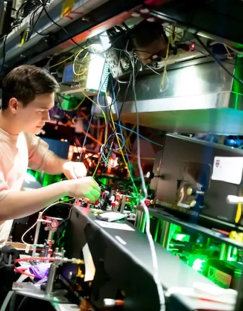 Andrew Winnicki, a rising senior studying physics and math, works with lasers in the Doyle Lab.