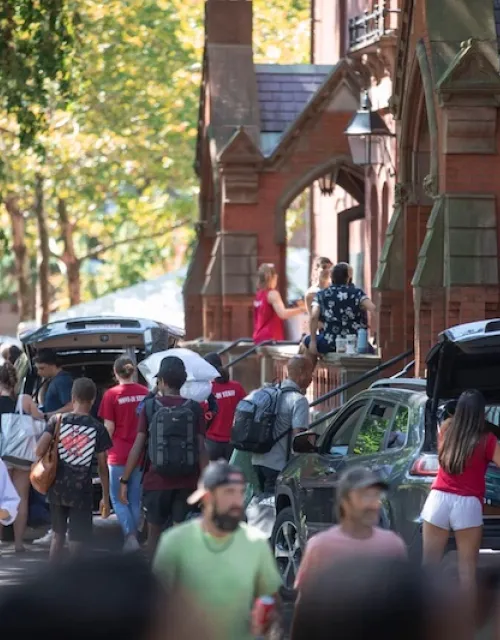 Move-in teams, family, and friends help first-year students make their way into a bustling Harvard Yard.
