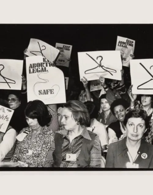 At the International Women's Year conference in Houston in 1977, attendees hold clashing signs on abortion rights.