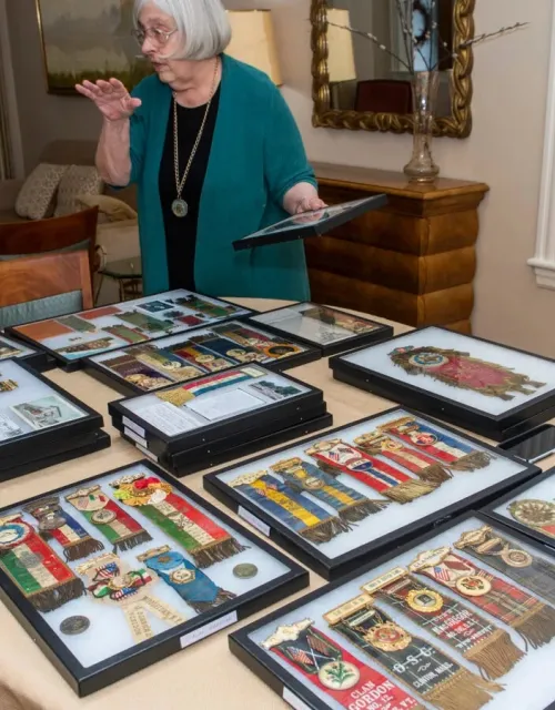 Theda Skocpol displays her collection of badges from early U.S. fraternal groups.