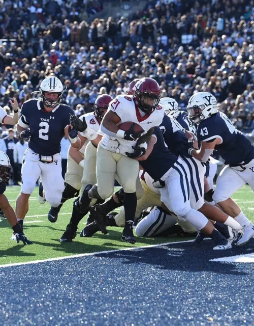 Football players at end zone of Harvard Yale