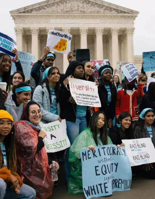 Harvard students rally outside the Supreme Court with "Defend Diversity" Posters