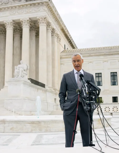 Seth Waxman speaks, standing on Supreme Court steps