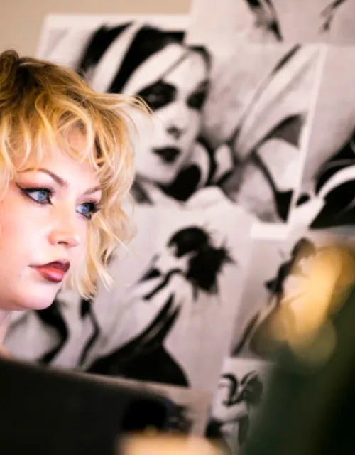 Animator Dasha Bough ’23 staring off screen with a pointed look in front of a black and white background. 