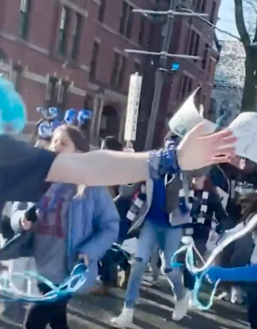 students from cabot house wearing all blue running in the yard on housing day