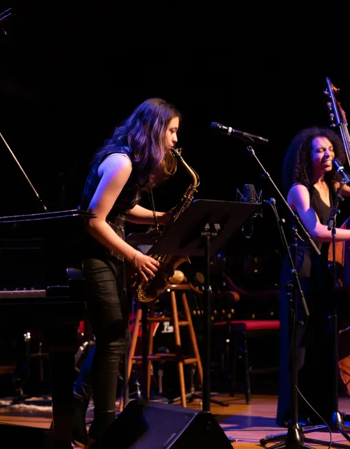 Saxophone and double bass player perform onstage at Arts First 2022