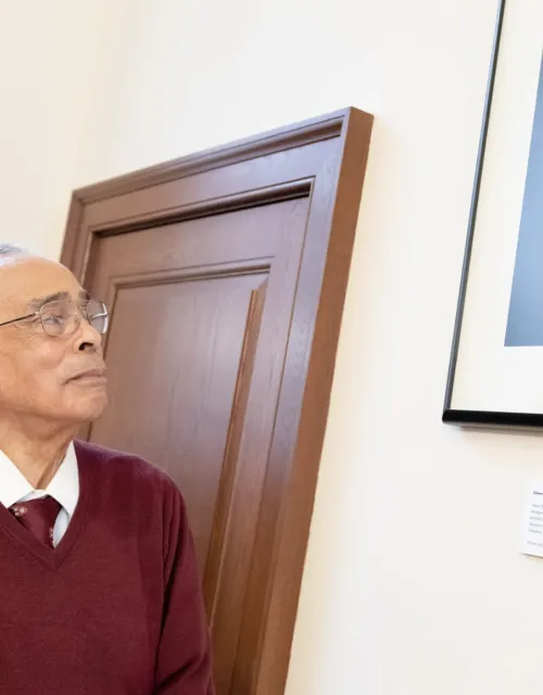 Spencer Jourdain gazes at the tribute to his father, Edwin Bush Jourdain Jr., after its recent reveal in Winthrop House