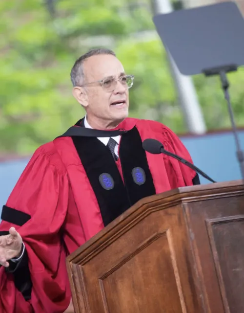 Tom Hanks, wearing regalia at the podium giving his speech on Commencement Day 