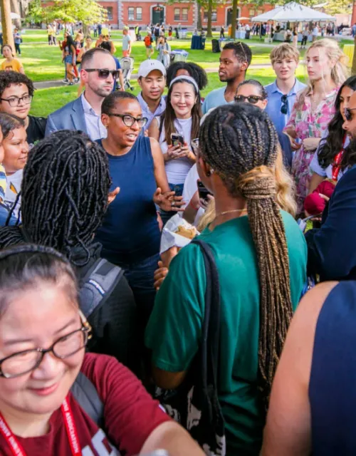 During one of her three stops for ice cream, Harvard President Claudine Gay (center) meets with the community in front of Massachusetts Hall in Harvard Yard.