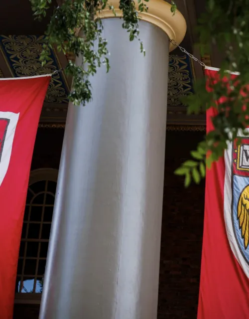 Banners hung on outside of Memorial church with Harvard logo