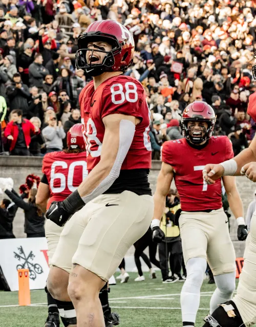 A Harvard football player celebrating on the field.