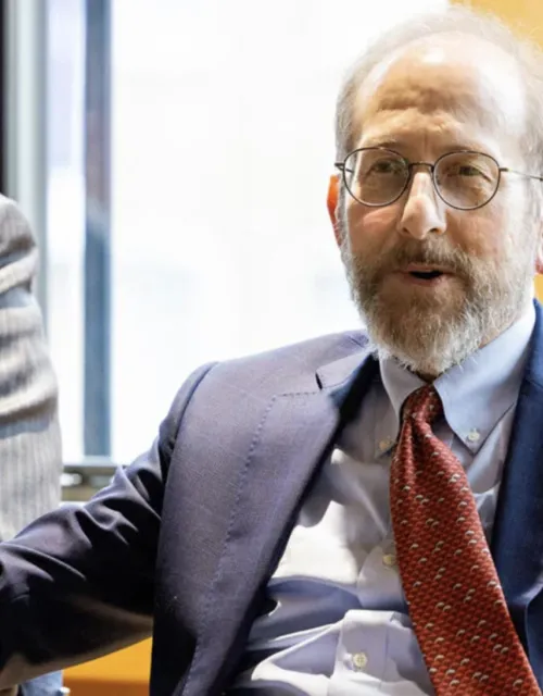 During his trip to the U.K., Interim President Alan Garber spoke with the Herchel Smith Scholars at Emmanuel College, Cambridge. Eric Miska (left), Herchel Smith Professor of Molecular Genetics, moderated the symposium