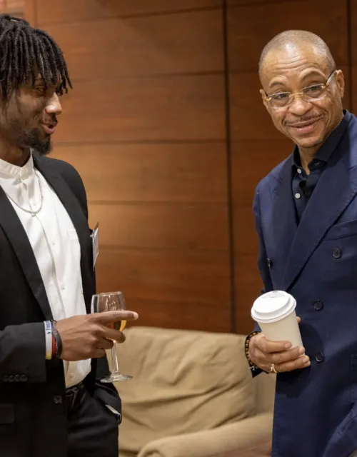 Kaleb Moody ’24 (left) talks with Gus Johnson, who returned to Dunster House to share his story with students