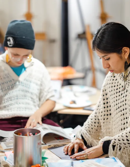 Students working around a table making art