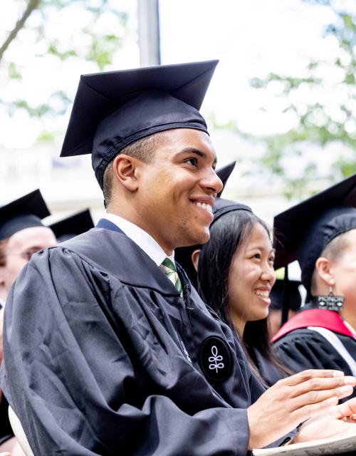 Student sitting in audience at commencement. 