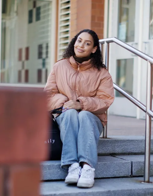 As a high school student, Maya Counter ’24 led the effort to rename the residential Cambridge neighborhood where she grew up from Agassiz to Baldwin. She is pictured outside her elementary school, named after educator and civic leader Maria L. Baldwin, the first Black school principal in the Northeast.