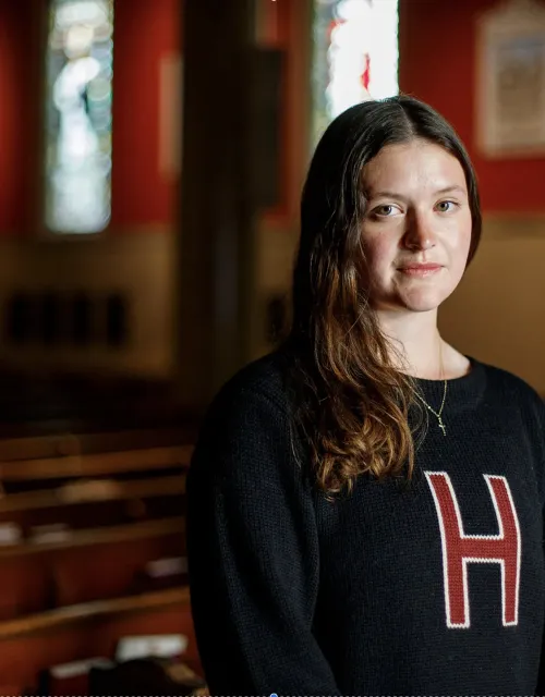 Faith Schmidt ’25 inside St. Paul’s Parish in Harvard Square.