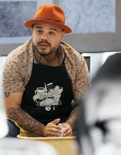 Man sitting and making pottery 