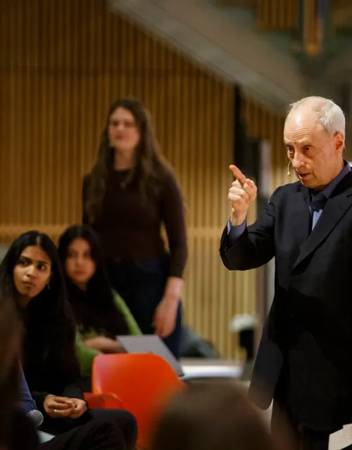Speaker engaging with audience in a lecture hall