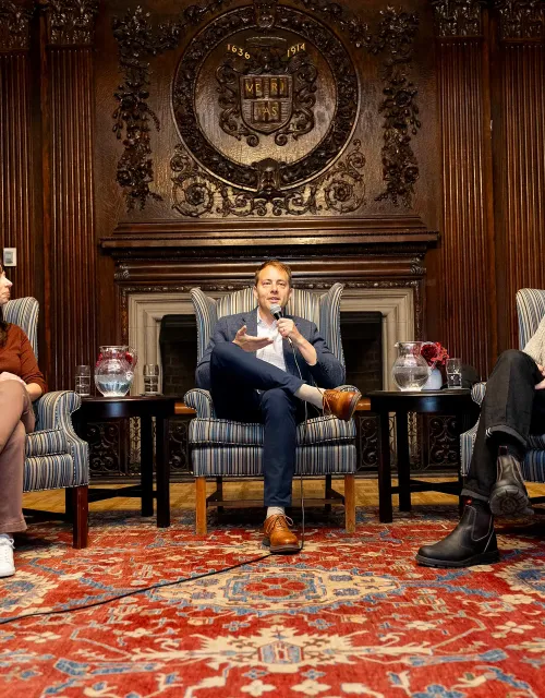 Harvard canine researcher Erin Hecht (left) and photographer Elias Weiss Friedman (right) of “The Dogist” Instagram account join Faculty Dean David Deming for a talk at Kirkland House.