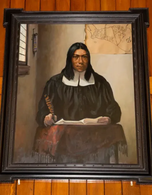 A portrait of Caleb Cheeshahteaumuck, the first Native American to graduate from Harvard College, hangs in Annenberg Hall.