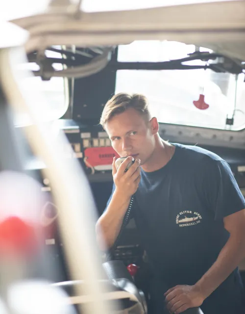 Dmitry holds a radio to prepare for boat mission readiness. 