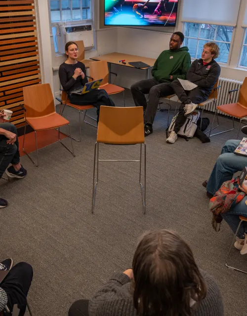 A group of students sitting in a circle during an Arts Wintersession program.