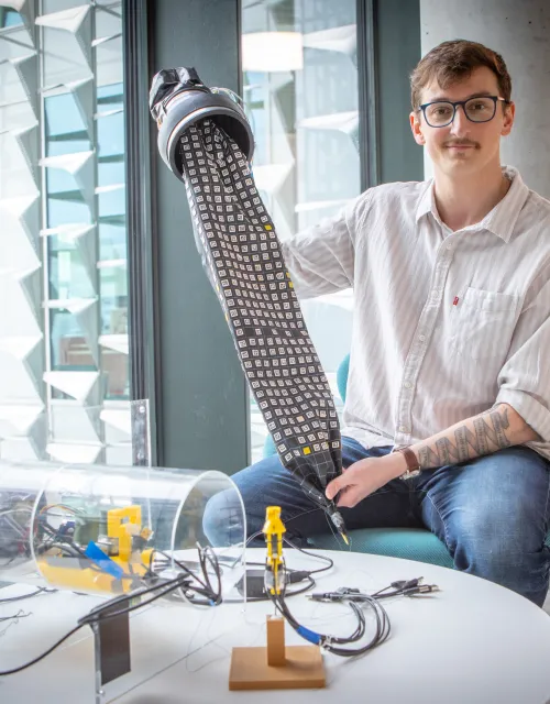 Viktor '26 holding up a piece of his thesis project.