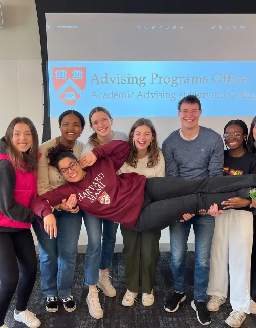 A group of PAF students holding up a female student.