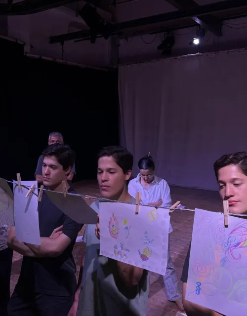 Identical triplets Carlos, Federico, and Francisco Valldejuly ʼ29 studying artwork together during their internship.