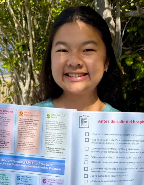 Header image of Sydney Mafong '30 holding up a printout of her SPARK project against a background of her work.