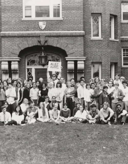 A group of students posing for a picture together outside of Adams House in 1987.