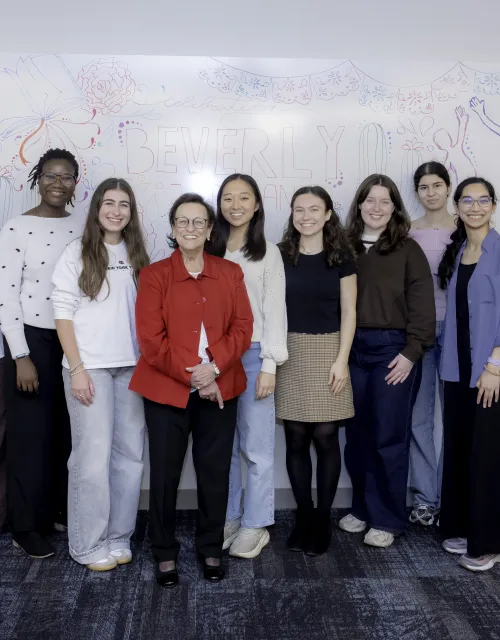 A group of peer tutor students smiling for a photo with donor Beverly J. Duran, center.