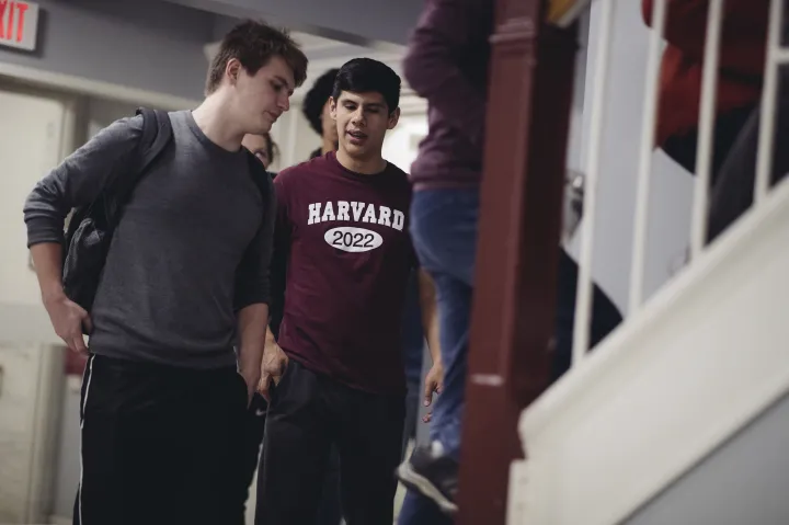 Two students walking up the stairs