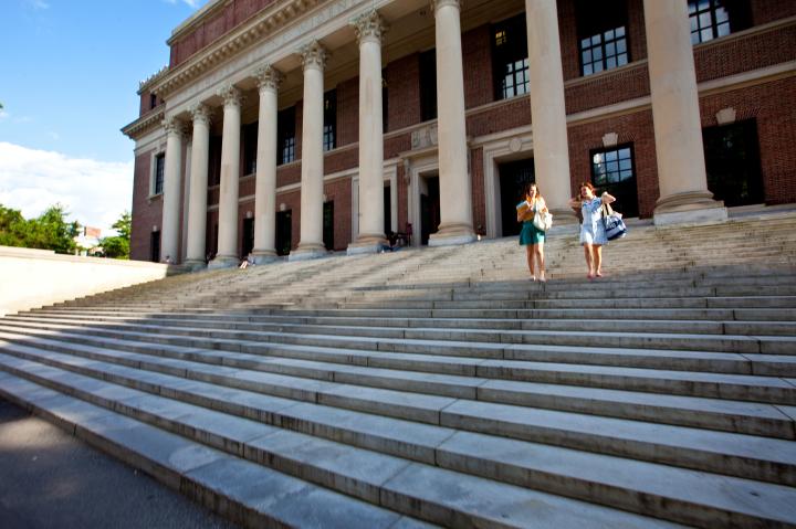 Two students walking down the steps of Widener Library