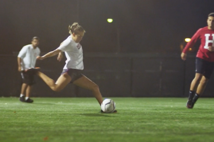 A student preparing to kick a soccer ball