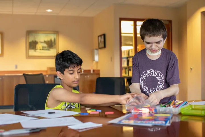Ben Elwy '23 (right) is teaching Arabic and cultural education to children at the Wellesley Free Library. 