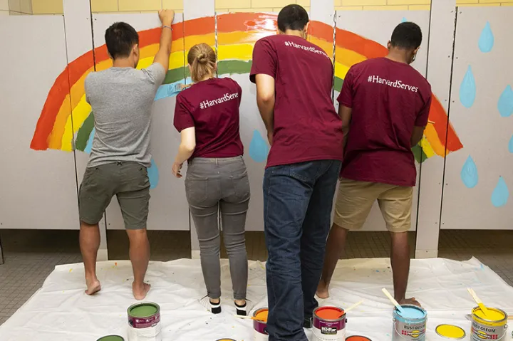   First-year students brighten up a bathroom at Winship Elementary School in Brighton during Harvard’s Day of Service.