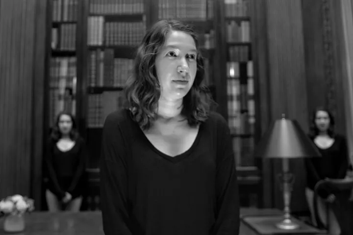 A student recites a collaborative story in the Harry Widener Memorial Room at Widener Library