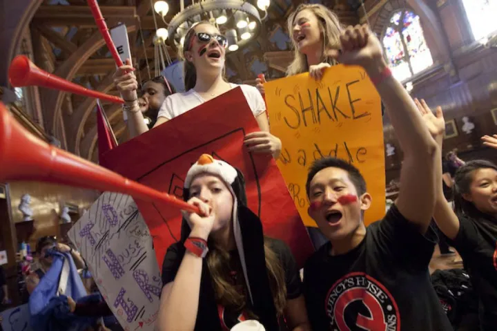 Students celebrating Harvard festivities in dining hall