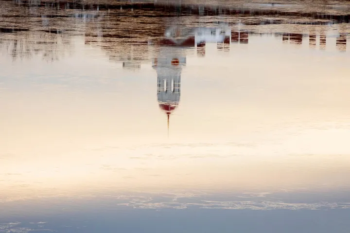A reflection of Harvard's campus on the Charles River.