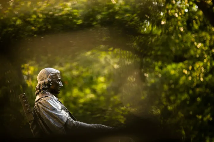 The John Harvard Statue overlooks Harvard Yard.