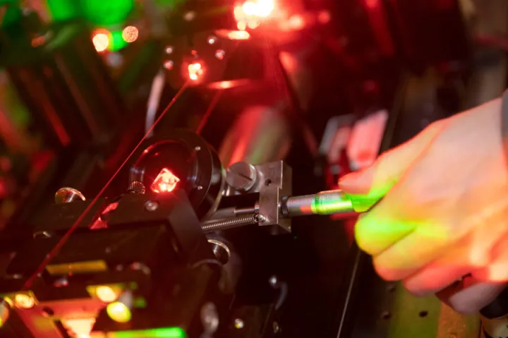 Working with lasers in the Doyle Lab.