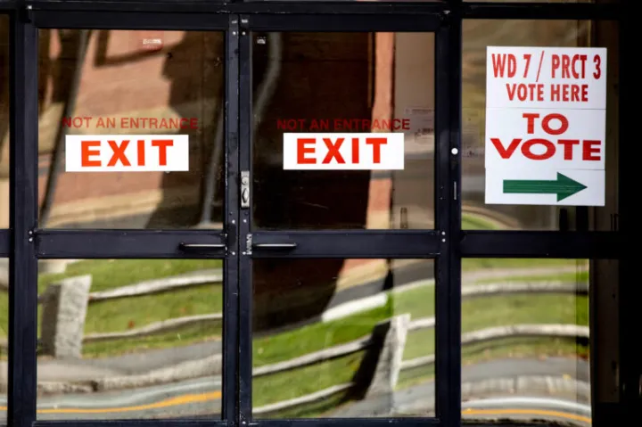 At the polls, there are signs pointing in the direction of where individuals should go to cast their ballots.