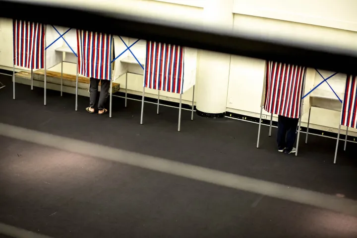 Individuals voting at the polls.