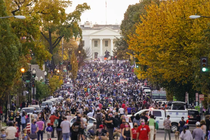 A crowd gathers along 16th Street in front of the White House on Saturday to celebrate the presidential race being called in favor of President-elect Joe Biden.