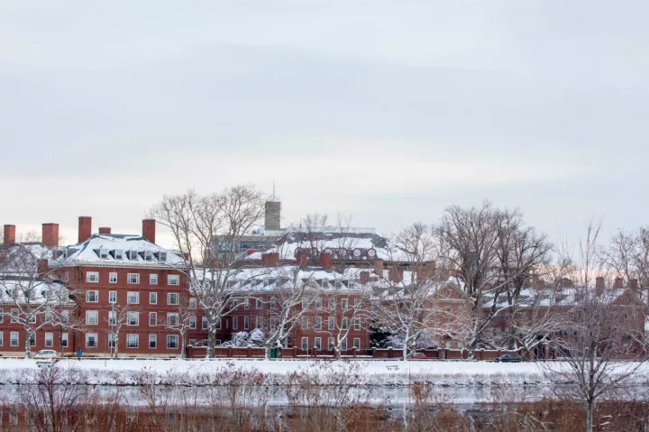 The towers of Eliot and Lowell Houses are pictured along the Charles River after a 2019 winter storm. 
