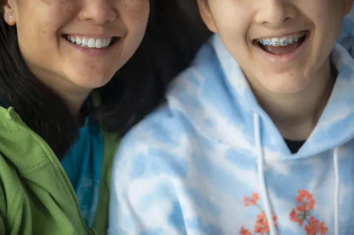 Two individuals smiling.